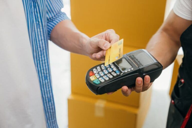 Man paying a mover with a credit card after a move