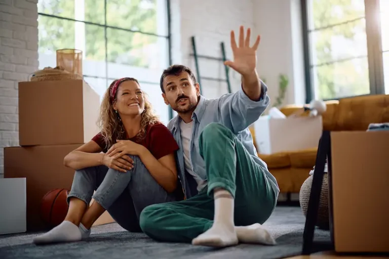 A young couple happily planning a long-distance relocation