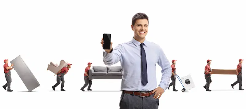 Manager of a moving company with movers in the background