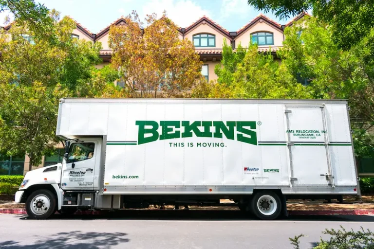 Moving truck waiting outside the apartment to be loaded with household items